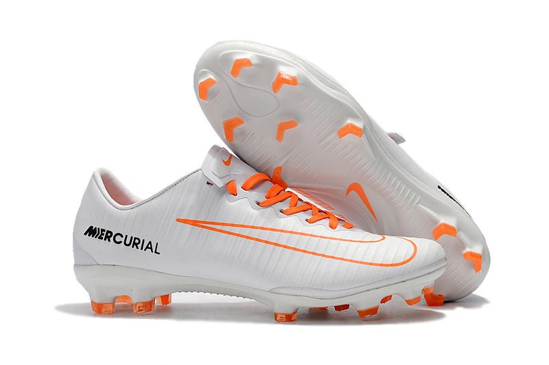 white and orange football boots
